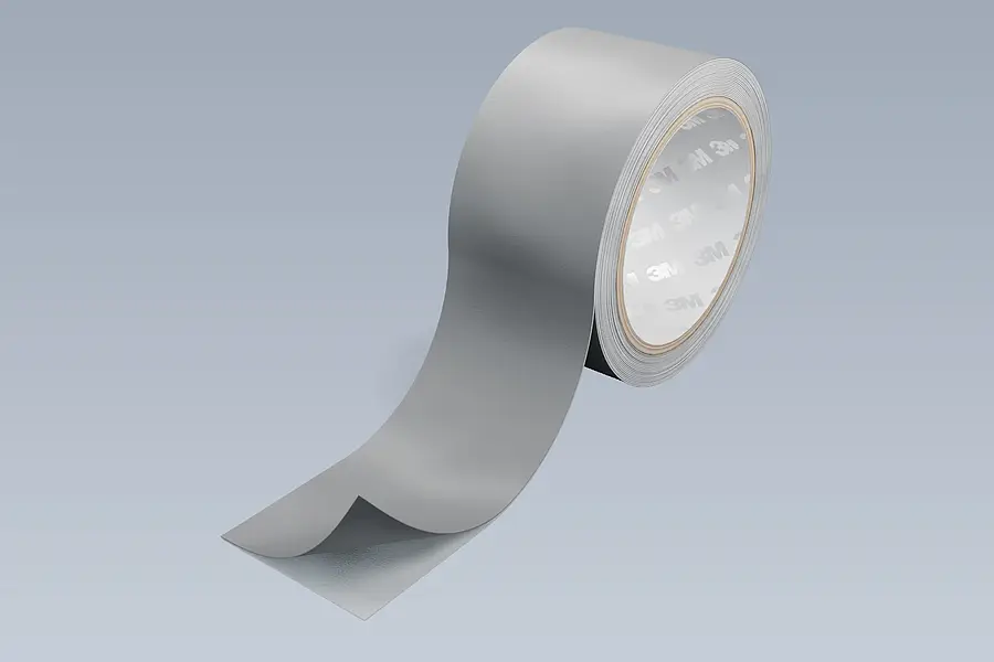 Grey laminate on a roll with a visible liner as an example of multilayer base material
