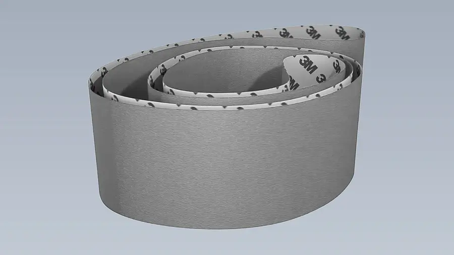Long closed sanding belt against a plain background