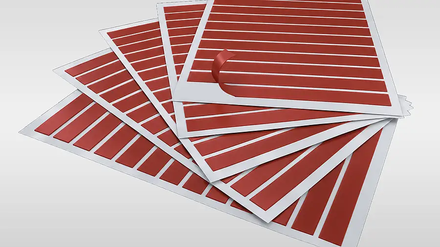 Narrow red strips in rows on white sheets
