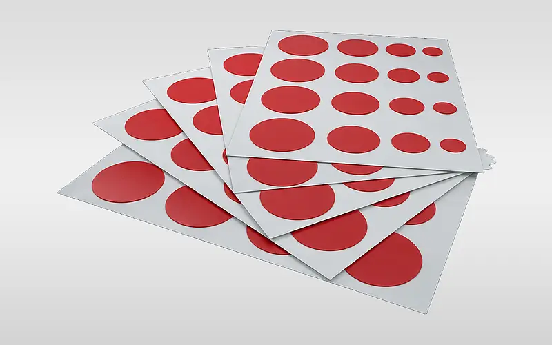 Red circular pads in different sizes on white sheets