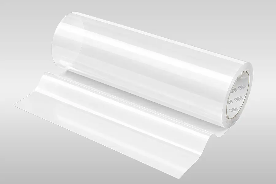 Transparent roll of single-sided film adhesive tape with an unwound web