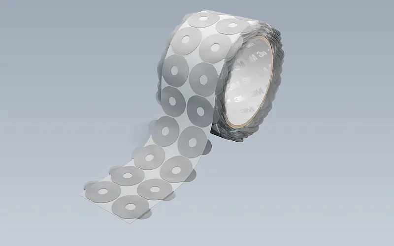 Illustration of die-cut adhesive parts with pull tabs on a roll