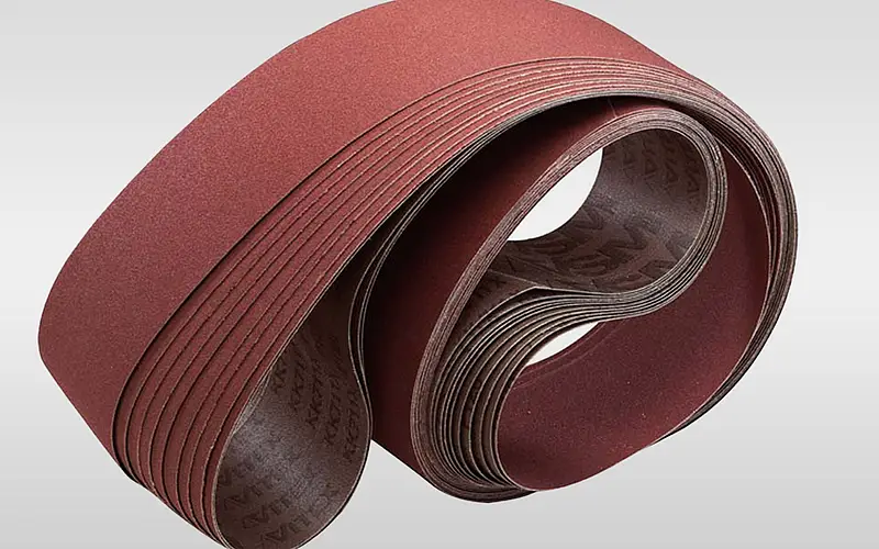 Finished closed abrasive cloth belts