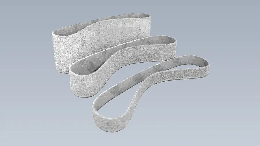 Closed nonwoven sanding belts against a plain background