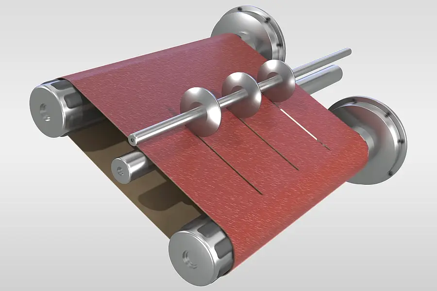 Coated abrasive web being cut into several belt widths on rollers