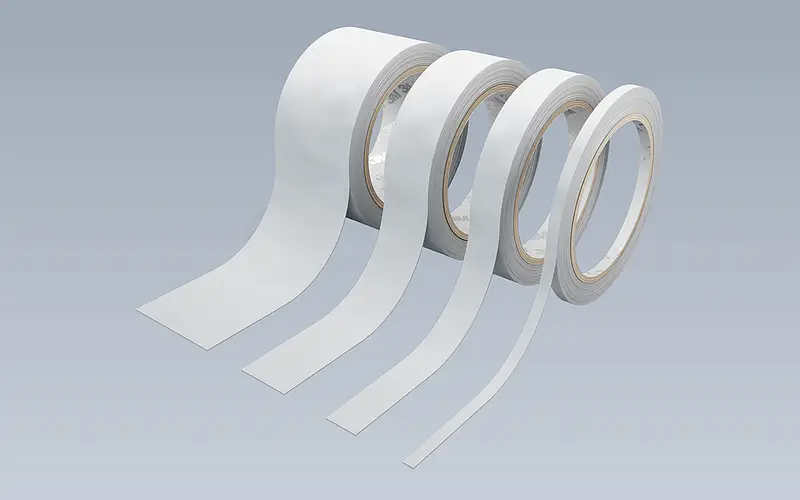 Four white rolls of different widths used to discuss roll formats