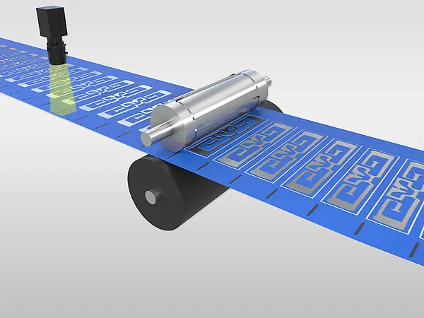 Rotary die cutting shapes contours in a blue material web