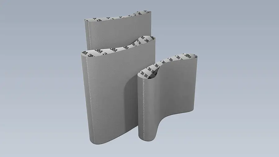 Wide closed sanding belt against a plain background